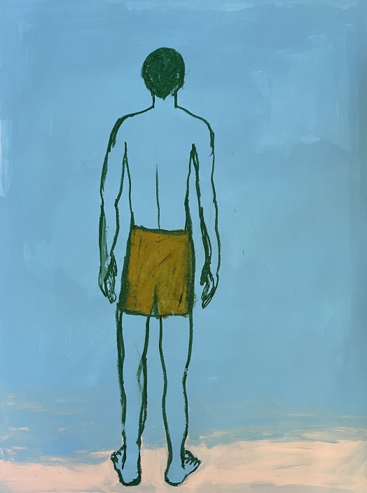 Homme debout devant l’océan
